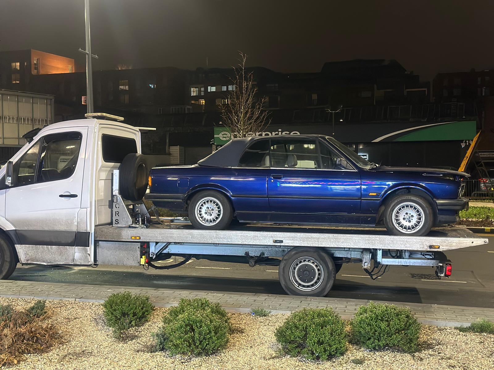 Classic BMW vehicle transport at night by BHX Logistics